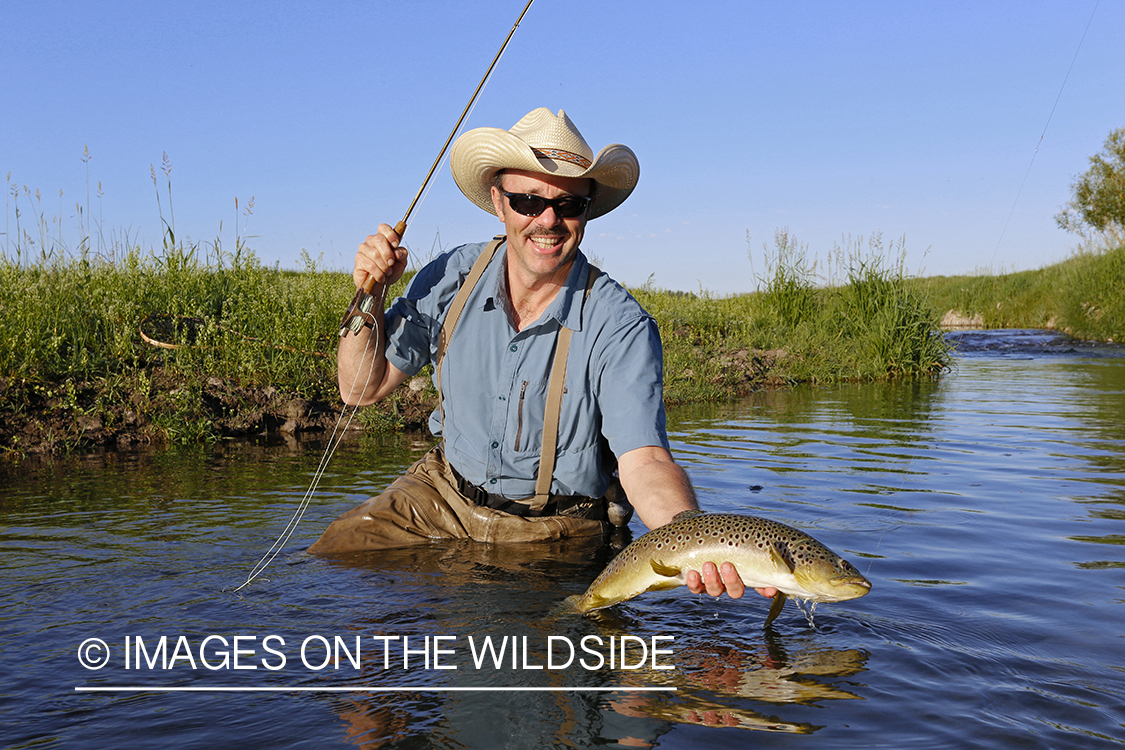 Flyfisherman with brown trout. 