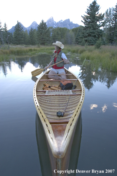 Woman in wooden canoe