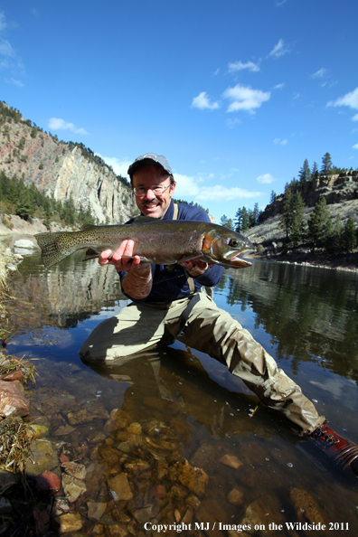 Flyfisherman with a nice rainbow trout.