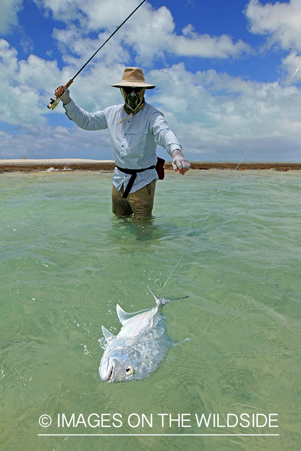 Saltwater flyfisherman with trevally fish, Christmas Island.