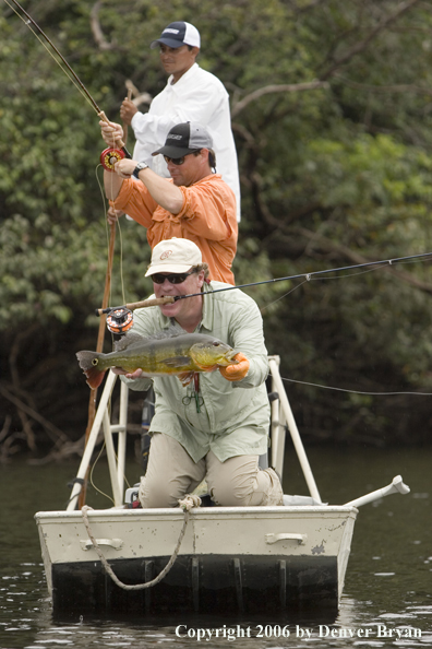 Fisherman holding Peacock Bass