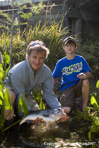 Fisherman and son with Largemouth Bass.  