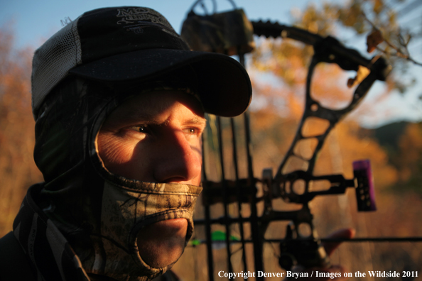 Bow hunter scouting for big game. 