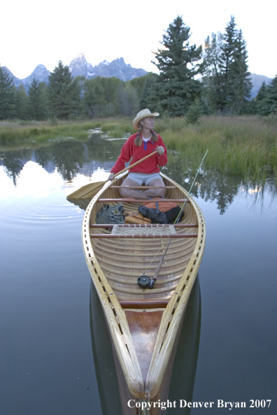 Woman in wooden canoe