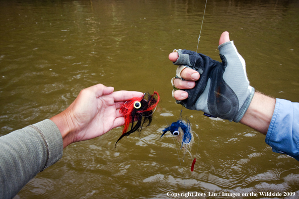 Flyfishermen holding flies