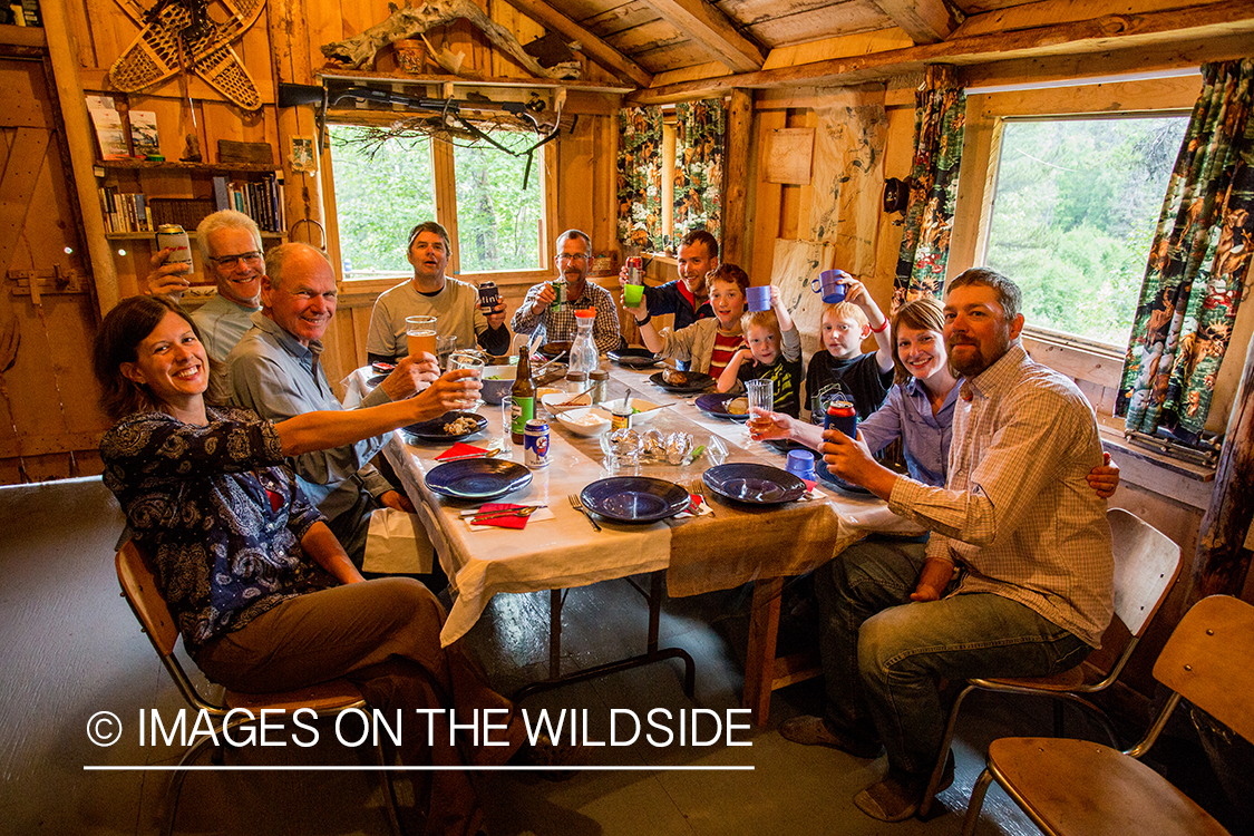 Flyfishermen with outfitter family in lodge on Nakina River.