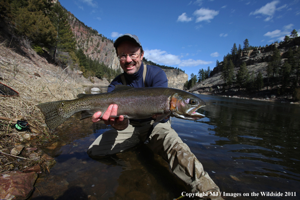 Flyfisherman with a nice rainbow trout.