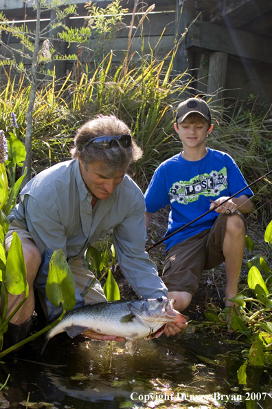 Fisherman and son with Largemouth Bass.  