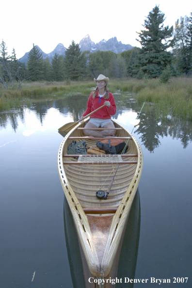 Woman in wooden canoe