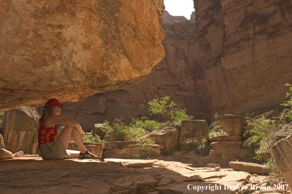 Hikers resting in shade of the Colorado River.  Grand Canyon.