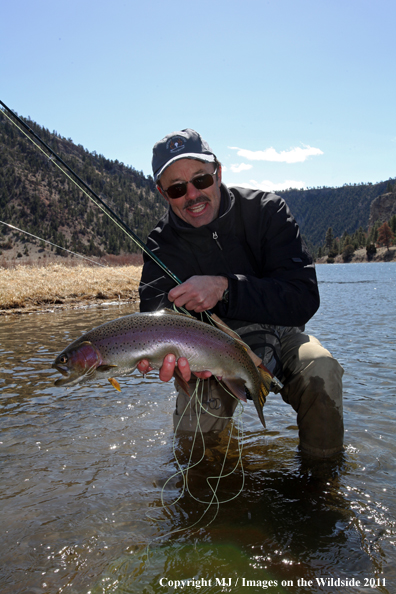 Flyfisherman with a nice rainbow trout.