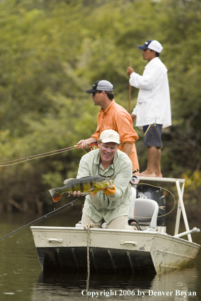 Fisherman holding Peacock Bass