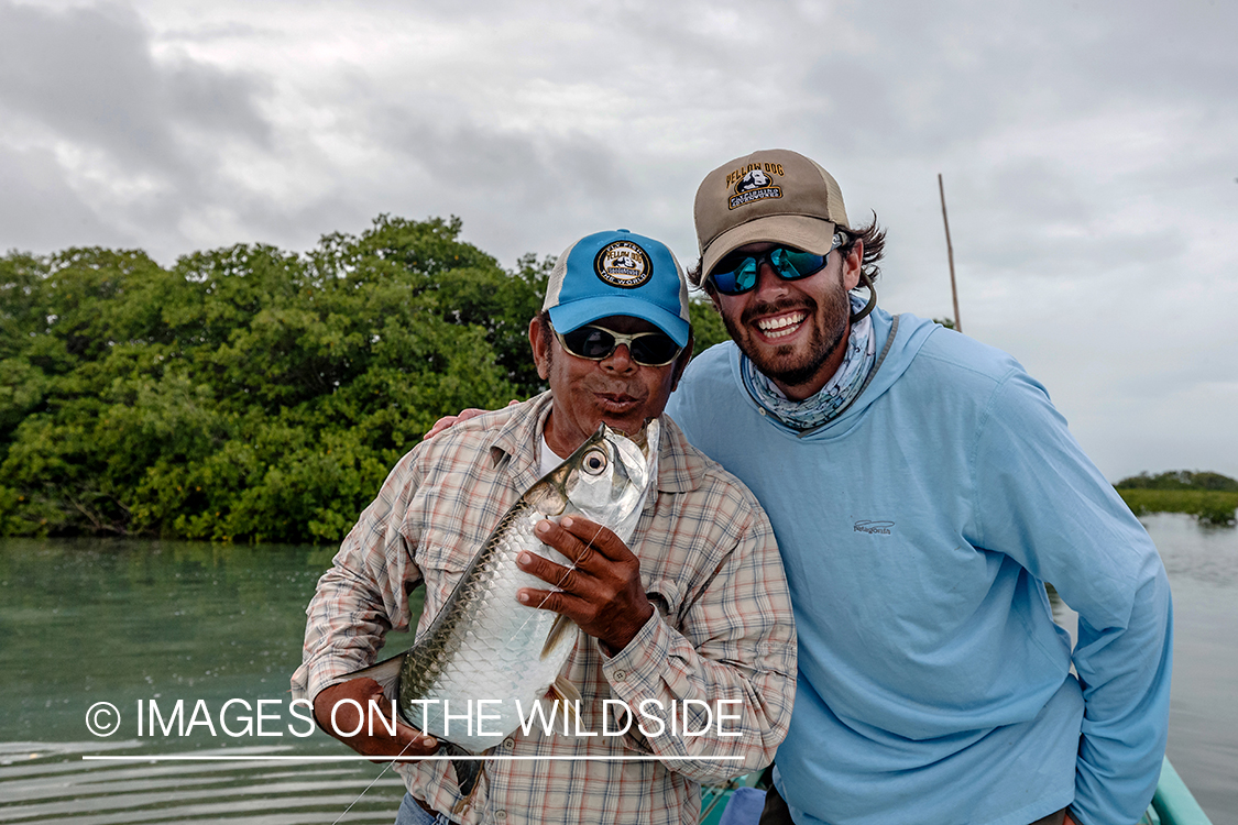 Saltwater flyfisherman and guide with baby tarpon.