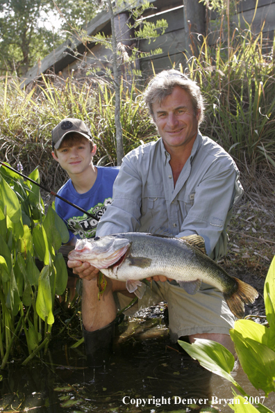 Fisherman and son with Largemouth Bass.  