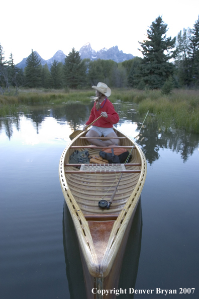 Woman in wooden canoe