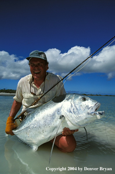 Saltwater flyfisherman holding trevally.