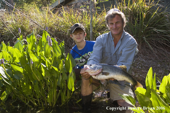 Fisherman and son with Largemouth Bass.  