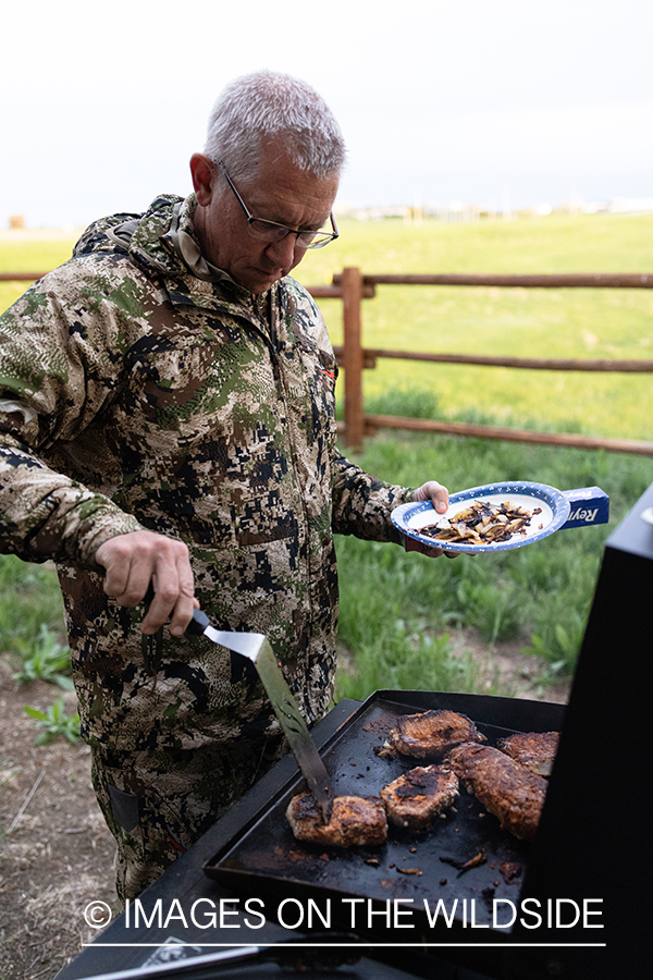 Turkey hunter grilling dinner.