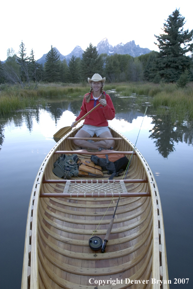 Woman in wooden canoe