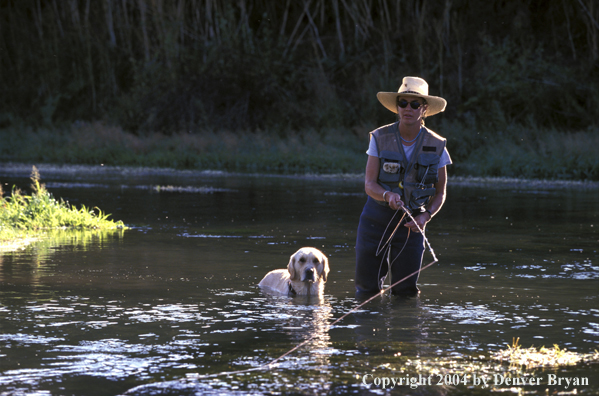 Woman Flyfisher with fish on line.