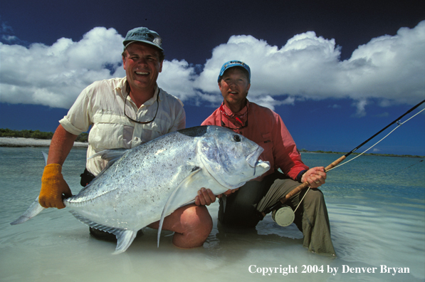 Saltwater flyfishermen holding trevally.