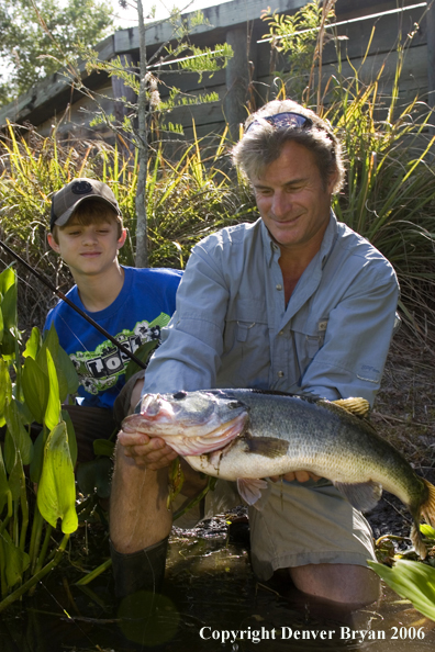 Fisherman and son with Largemouth Bass.  