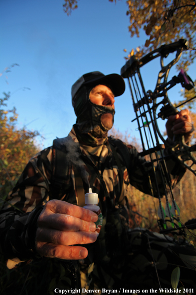 Bow hunter using wind smoke (powder) to test wind. 