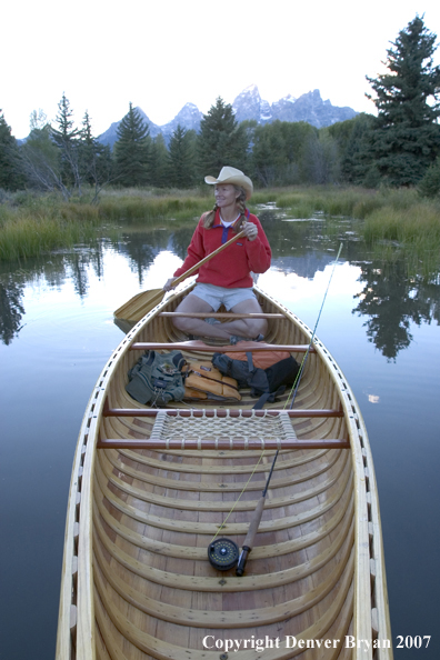 Woman in wooden canoe