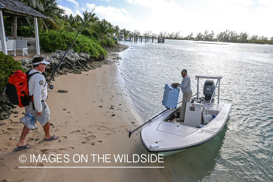 Flyfishermen loading gear on boat.