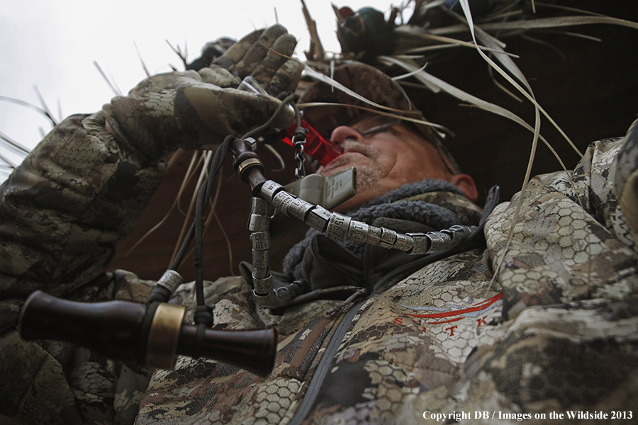 Waterfowl hunter duck calling.