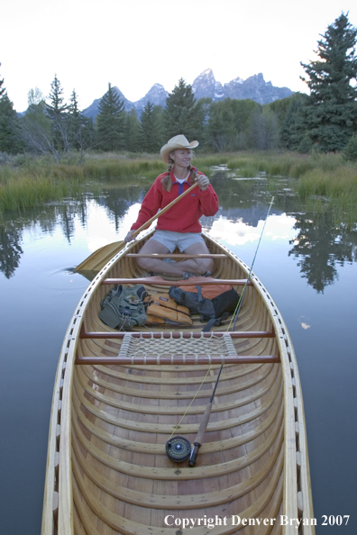 Woman in wooden canoe