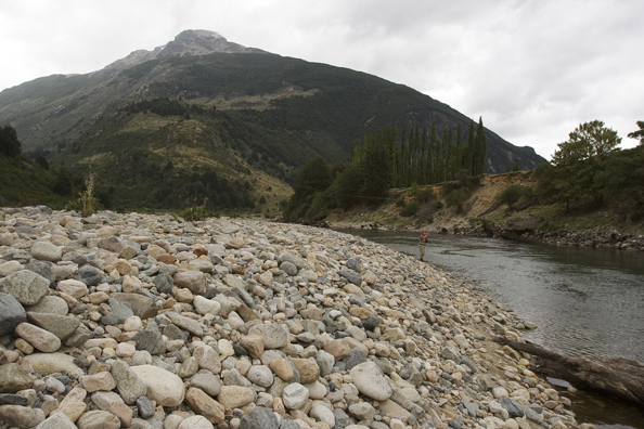 Flyfisherman casting on river.