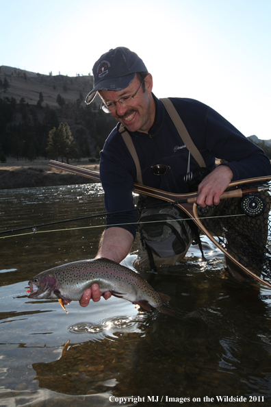 Flyfisherman with a nice rainbow trout.