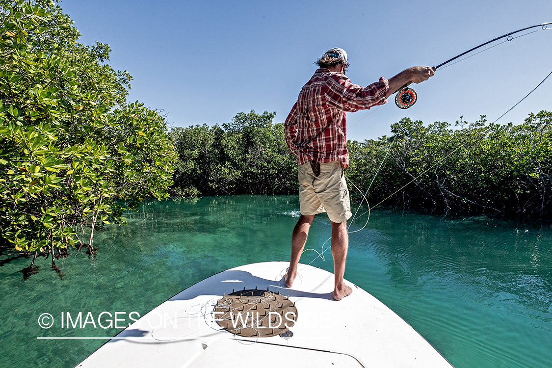 Flyfisherman fighting with bonefish.