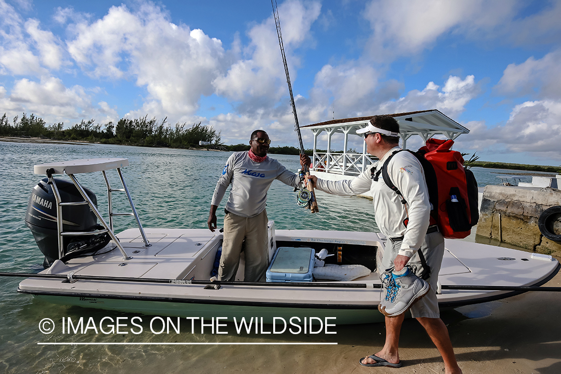 Flyfishermen loading gear on boat.