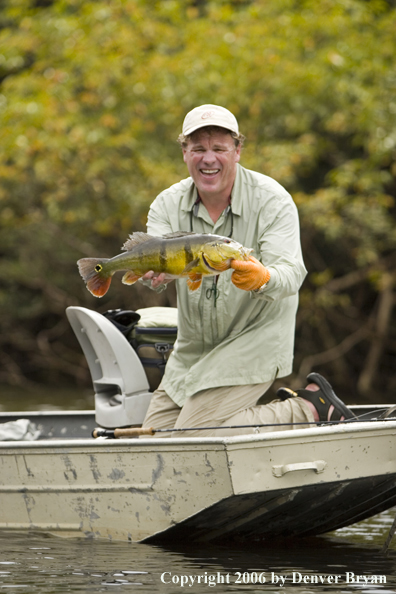 Fisherman holding Peacock Bass