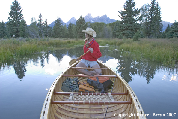 Woman in wooden canoe