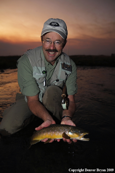 Flyfisherman with brown trout