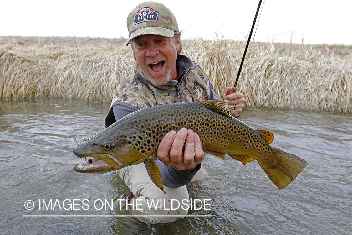 Flyfisherman with brown trout.