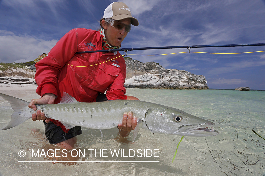 Saltwater flyfishing woman releasing bonefish.