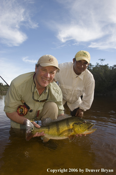 Fisherman holding Peacock Bass