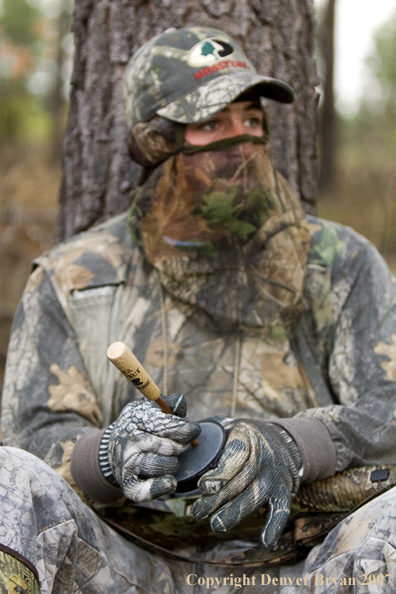 Turkey hunter calling in the field