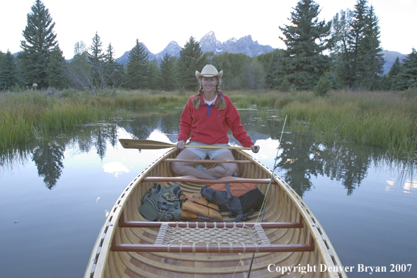 Woman in wooden canoe