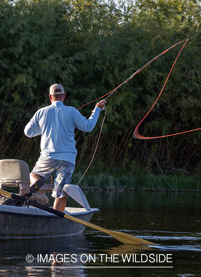 Flyfisherman casting from drift boat.