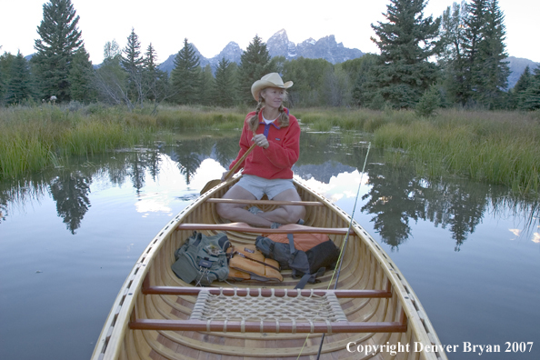 Woman in wooden canoe