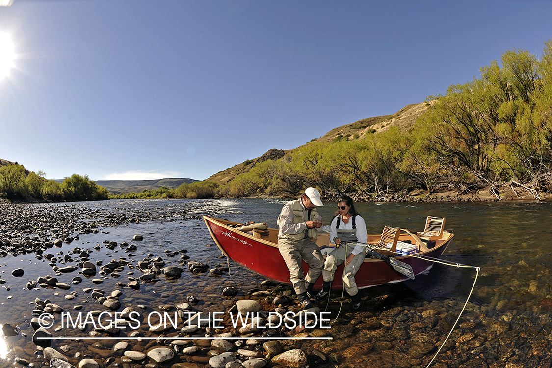 Flyfishers on river with drift boat.