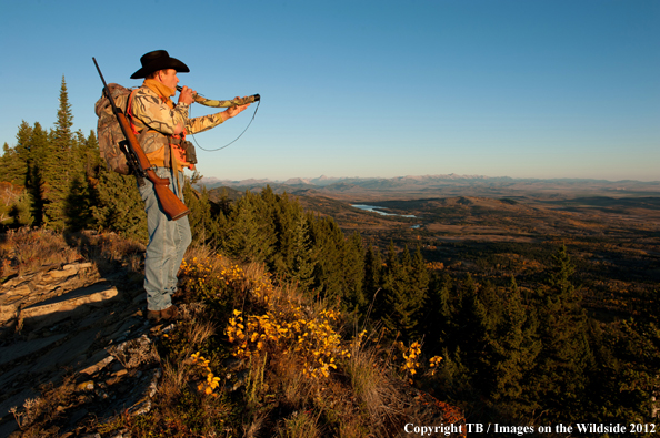 Big game hunter calling with elk bugle. 