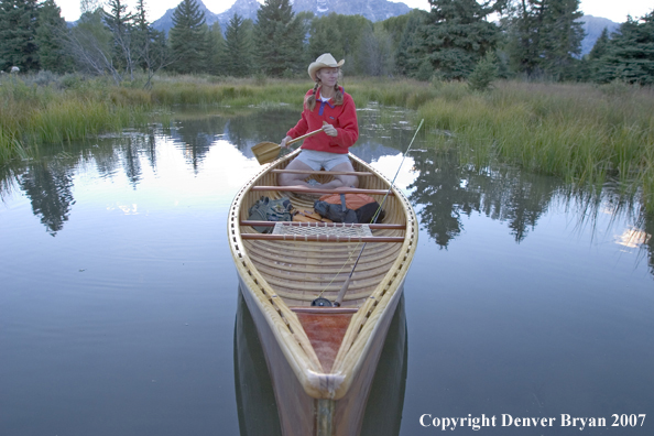 Woman in wooden canoe