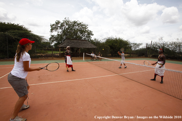 Family playing tennis on safari