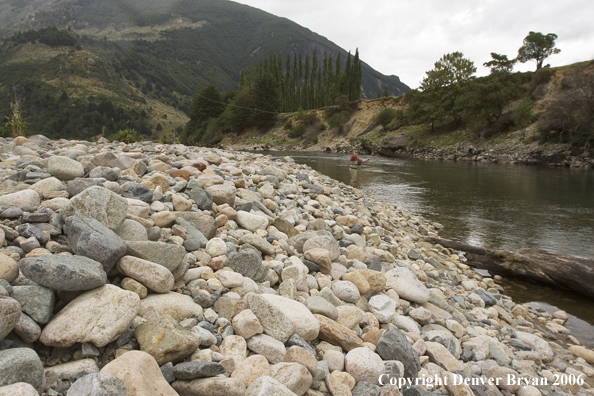 Flyfisherman casting on river.